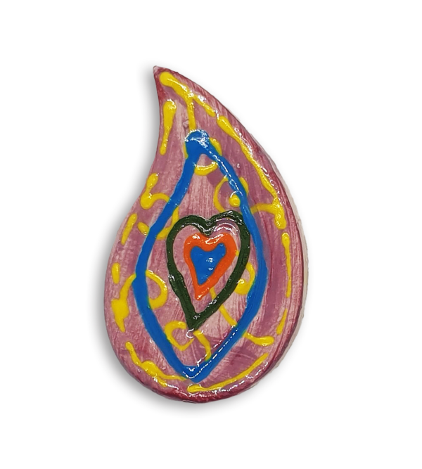 A hand-painted pink teardrop boteh boho motif ceramic mosaic insert with a blue heart design and blue detailing.