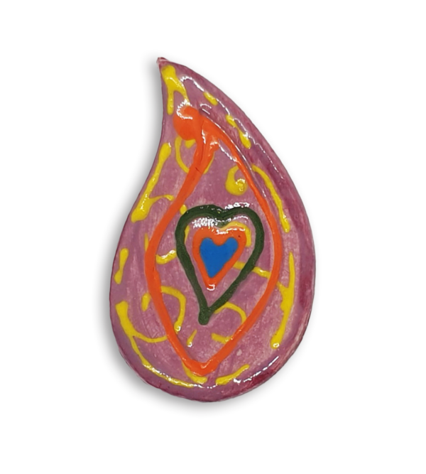 A hand-painted pink teardrop boteh boho motif ceramic mosaic insert with a blue heart design and orange detailing.