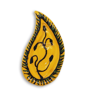 A hand-painted yellow teardrop boteh boho motif ceramic mosaic insert with a black vine or plant design.