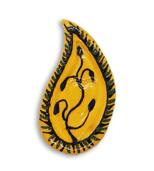 A hand-painted yellow teardrop boteh boho motif ceramic mosaic insert with a black vine or plant design.