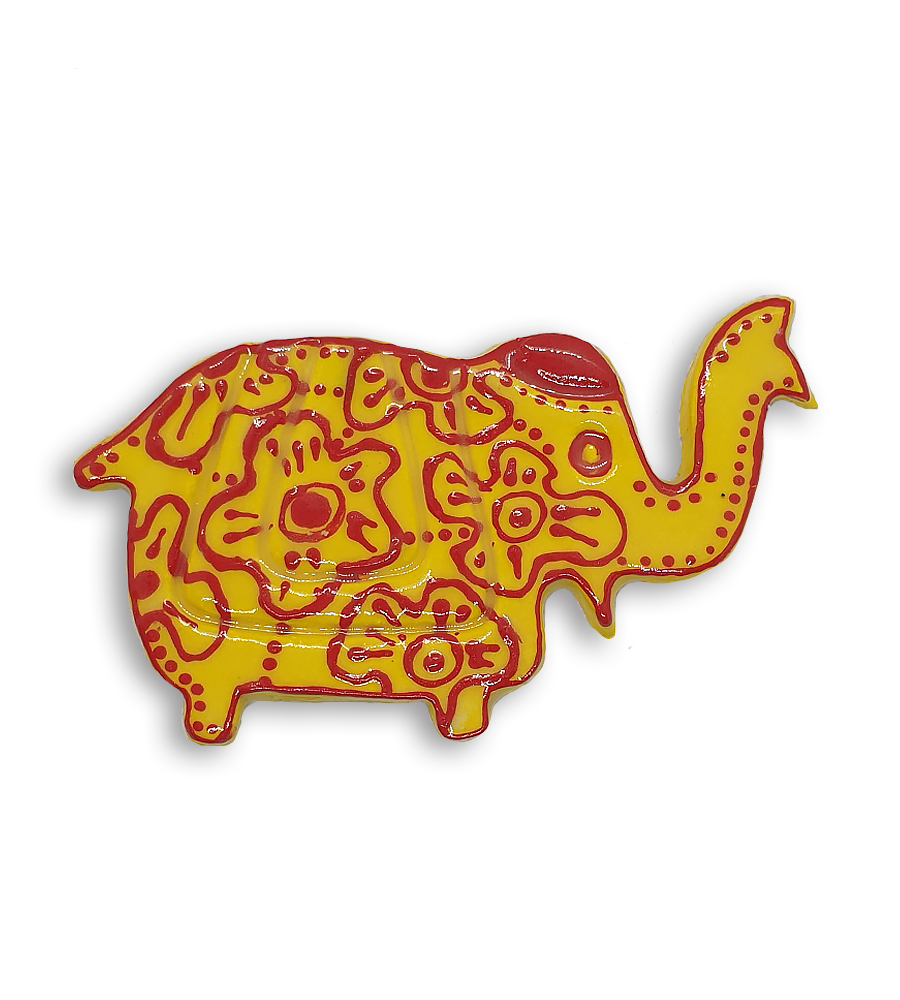 A yellow Indian elephant ceramic mosaic insert with hand-painted red designs.