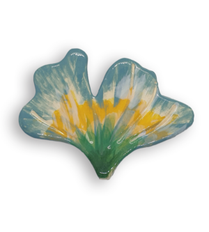 A hand-painted flower petal ceramic mosaic insert with green, yellow, blue and cream colours.