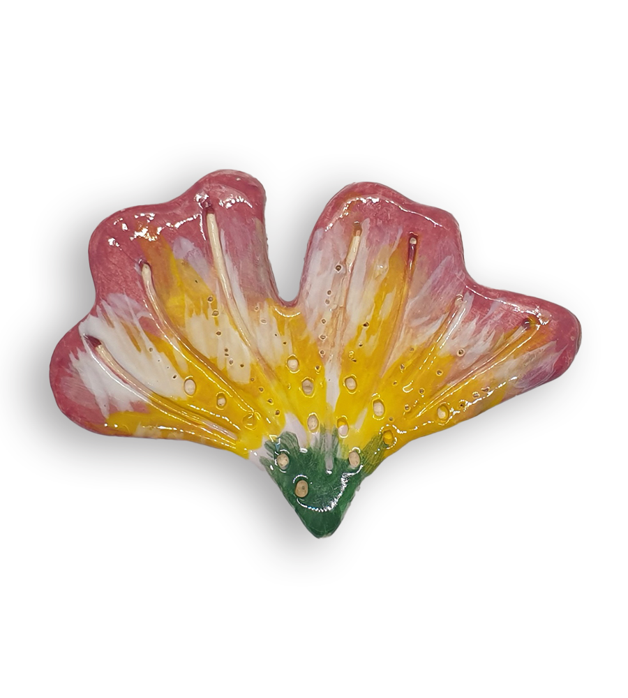 A hand-painted and textured flower petal ceramic mosaic insert with green, yellow, pink and cream colours.
