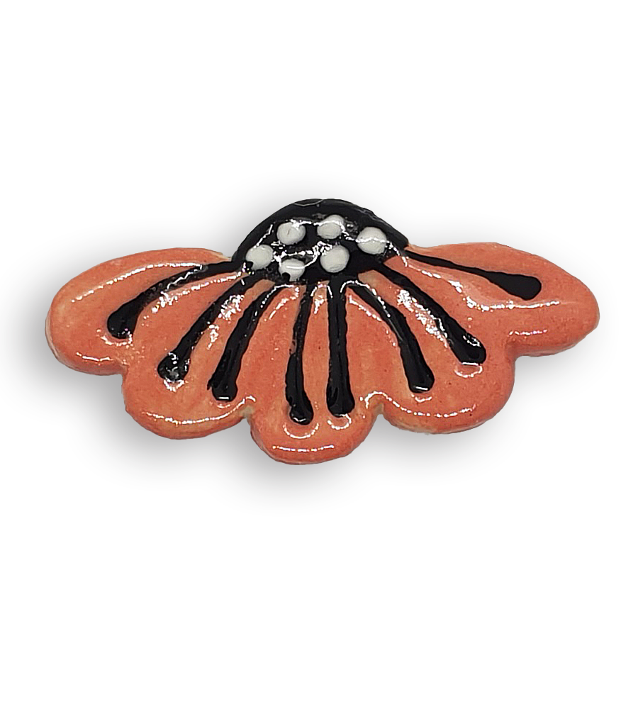 A hand-painted orange daisy flower ceramic mosaic insert with black and white details.