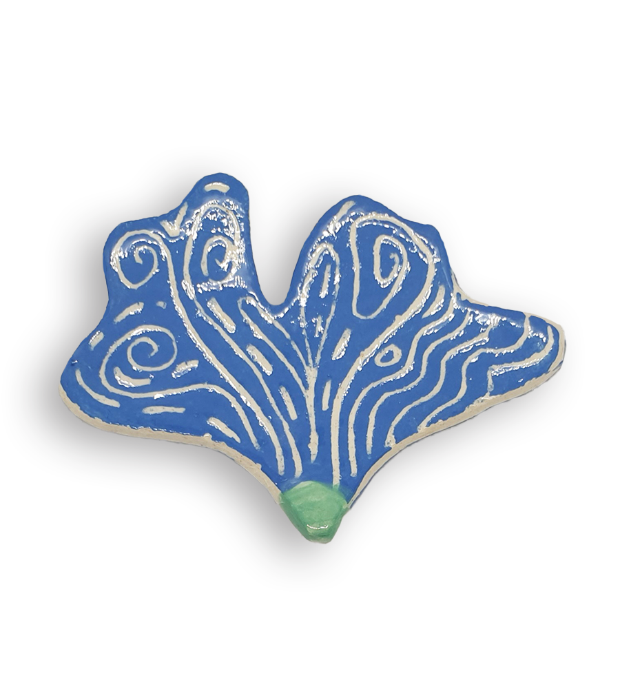 A hand-painted sky blue petal-shaped ceramic mosaic insert with white swirling designs.