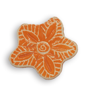 A hand-painted bright orange anemone ceramic mosaic insert with white swirling designs.