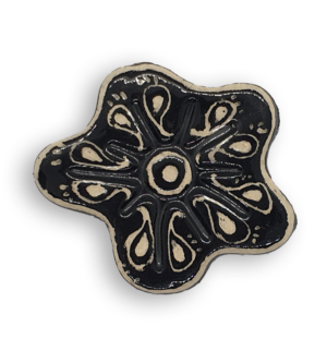 A hand-painted black anemone ceramic mosaic insert with white swirling designs.