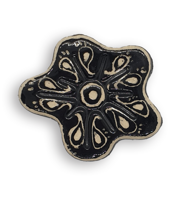 A hand-painted black anemone ceramic mosaic insert with white swirling designs.