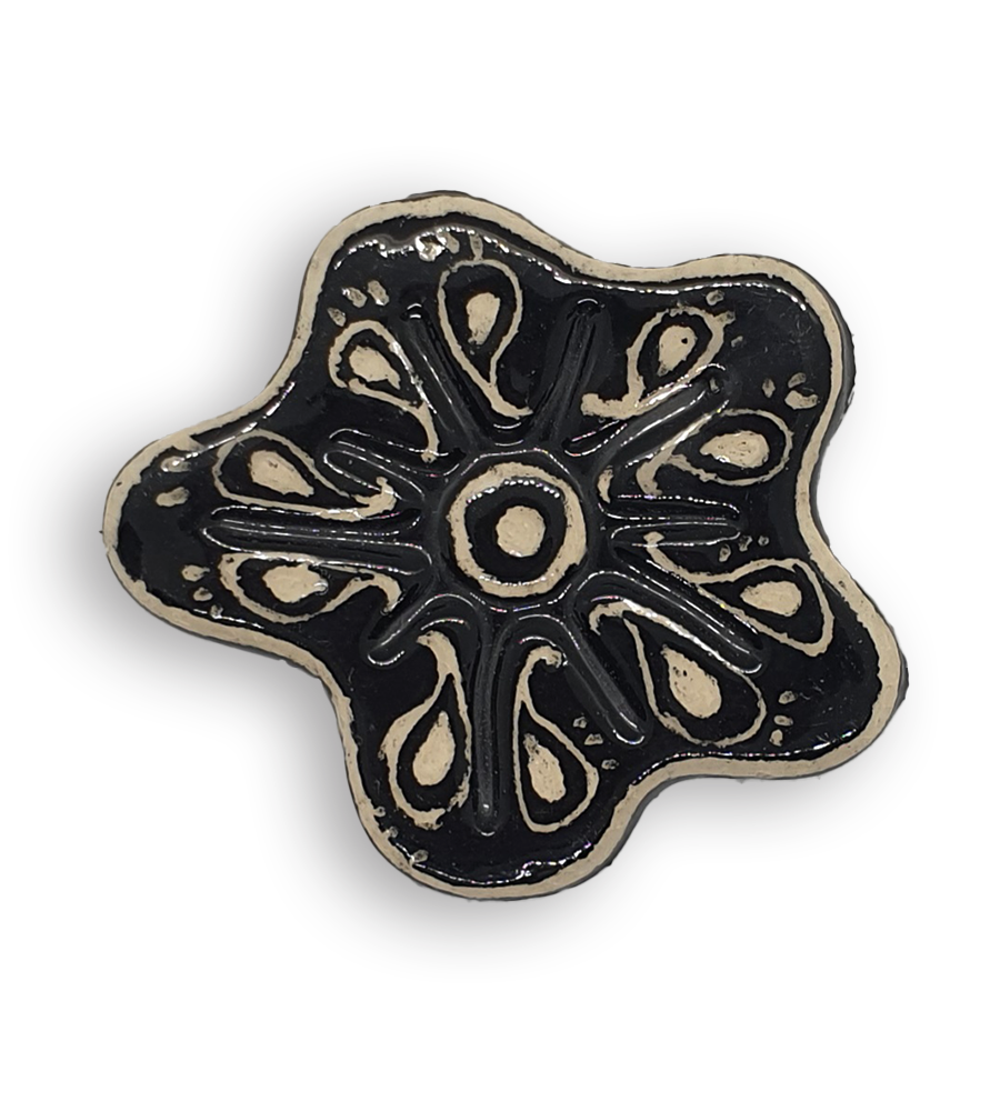 A hand-painted black anemone ceramic mosaic insert with white swirling designs.