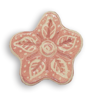 A hand-painted light pink anemone ceramic mosaic insert with white leaf-shaped designs.