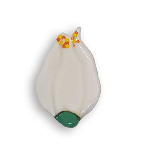 A hand-painted white flower ceramic mosaic insert with yellow and orange details in the shape of a tulip.