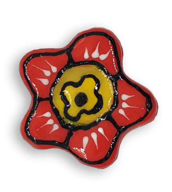 A hand-painted bright red anemone ceramic mosaic insert with black and white details and a yellow centre.