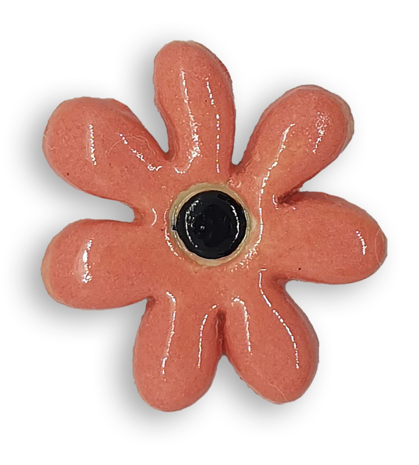 A peachy pink daisy flower ceramic mosaic insert with a black centre.