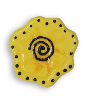 A yellow abstract flower ceramic mosaic insert with hand-painted black details.