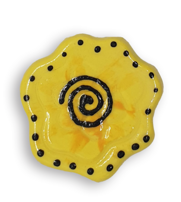 A yellow abstract flower ceramic mosaic insert with hand-painted black details.