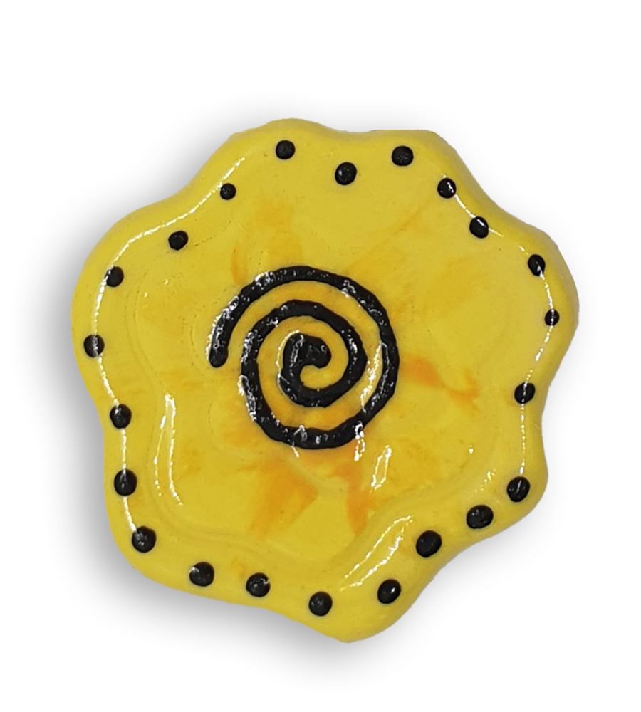 A yellow abstract flower ceramic mosaic insert with hand-painted black details.