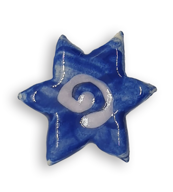 A blue star-shaped ceramic mosaic insert with a white spiral at its centre.