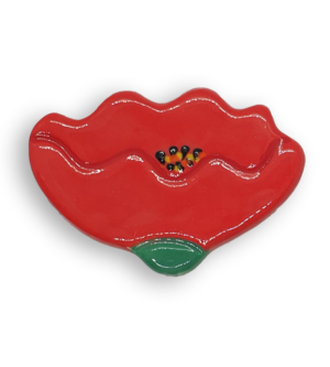 A hand-painted bright red buttercup flower ceramic mosaic insert with yellow and black details.