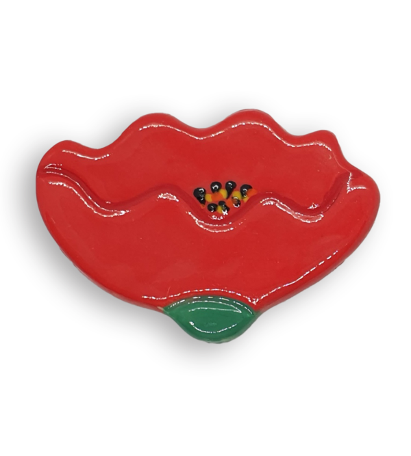 A hand-painted bright red buttercup flower ceramic mosaic insert with yellow and black details.