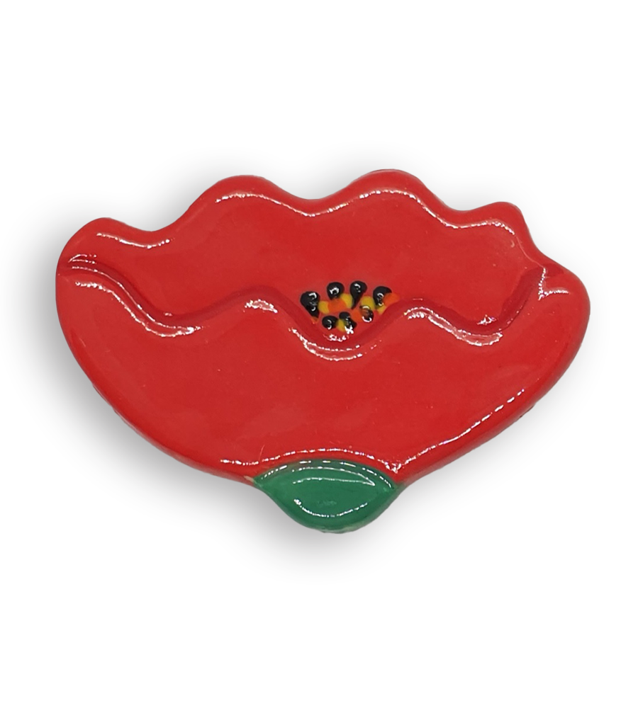 A hand-painted bright red buttercup flower ceramic mosaic insert with yellow and black details.