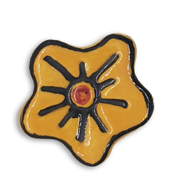 A hand-painted dark yellow anemone ceramic mosaic insert with black and red details.