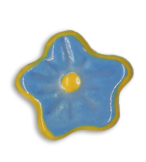 A hand-painted powder blue anemone ceramic mosaic insert with a yellow rim.