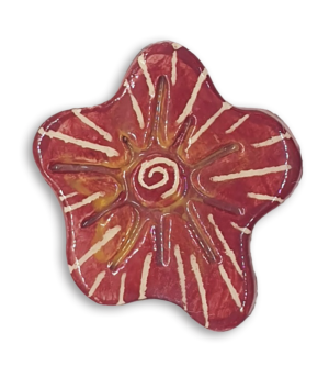 A hand-painted burgundy red anemone ceramic mosaic insert with a white starburst design.