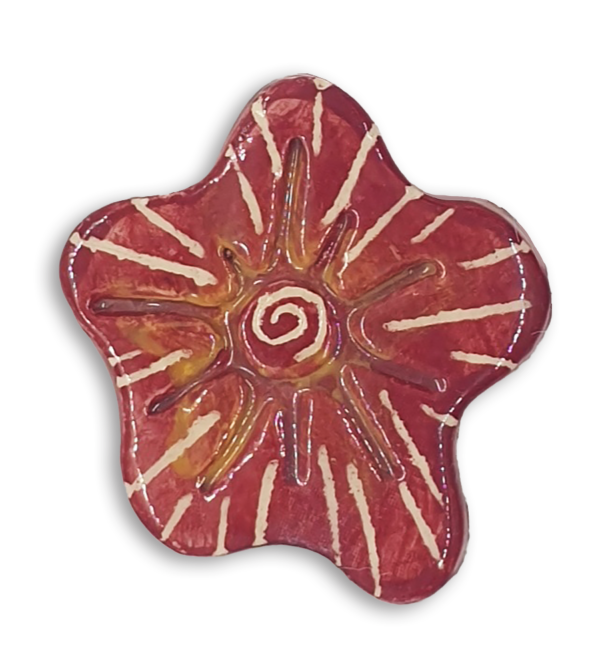 A hand-painted burgundy red anemone ceramic mosaic insert with a white starburst design.