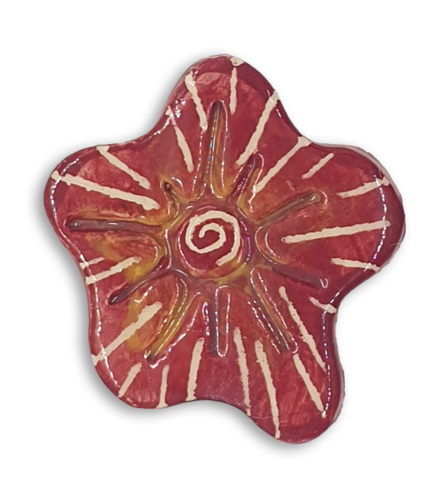 A hand-painted burgundy red anemone ceramic mosaic insert with a white starburst design.