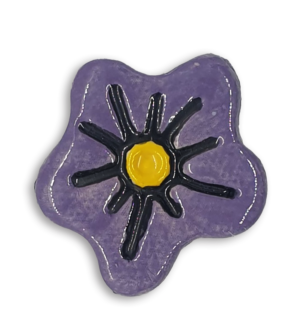 A purple hand-painted anemone ceramic mosaic insert with a yellow centre.