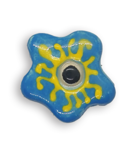 A turquoise blue hand-painted anemone ceramic mosaic insert with a black centre and a yellow design.