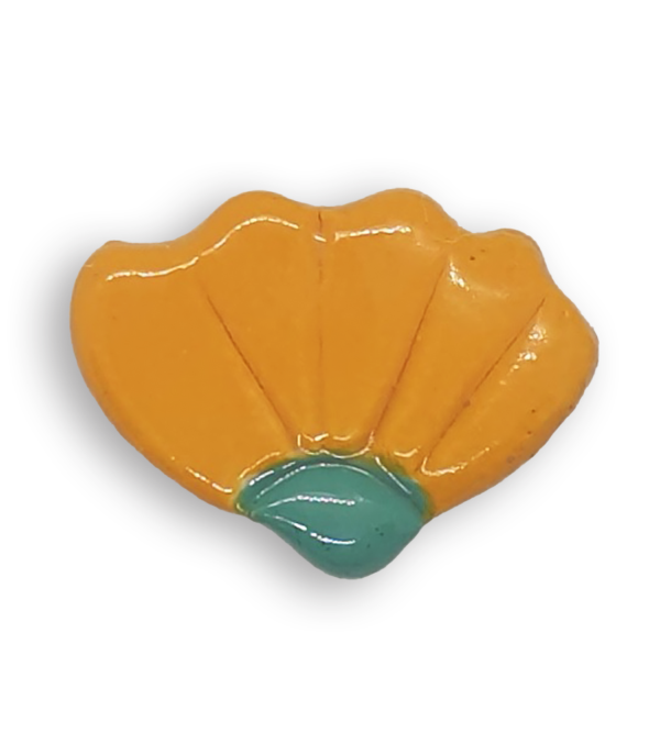 A dark yellow hand-painted ceramic mosaic insert shaped like a flower.