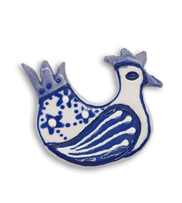 A hand-painted white and blue hen ceramic mosaic insert.