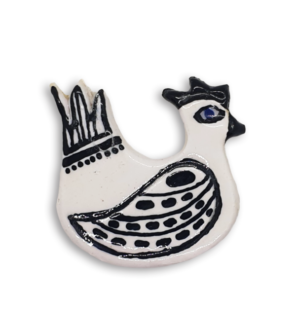 A hand-painted black and white hen ceramic mosaic insert.