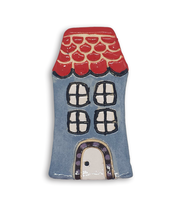 A hand-painted light blue English cottage house ceramic mosaic insert with red roof shingles design.