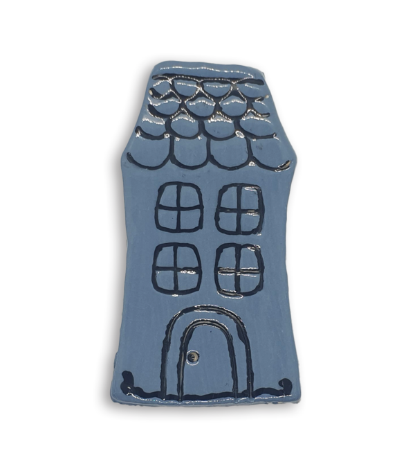 A hand-painted light blue English cottage house ceramic mosaic insert with roof shingles design.