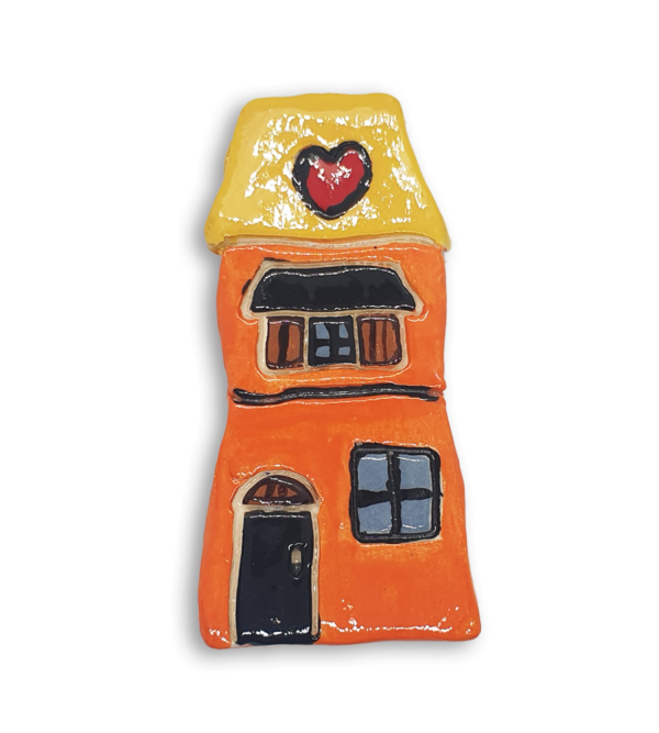 A hand-painted orange house ceramic mosaic insert with a yellow roof and red heart design.