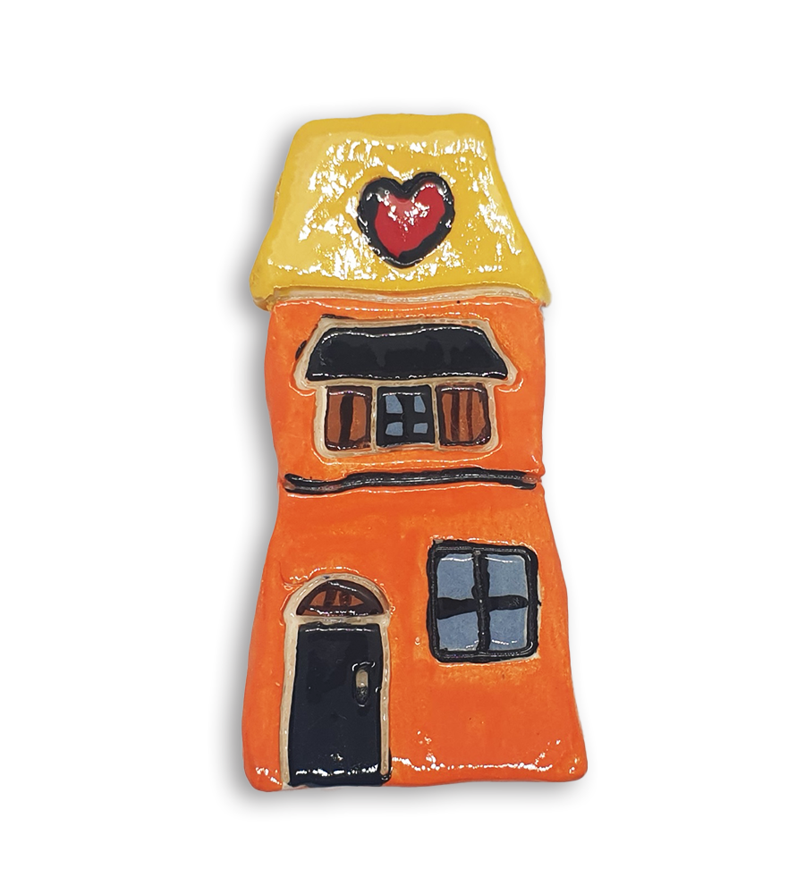 A hand-painted orange house ceramic mosaic insert with a yellow roof and red heart design.