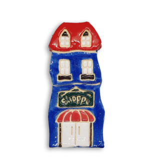 A hand-painted blue house ceramic mosaic insert with a red roof and old fashioned black Shoppe sign.