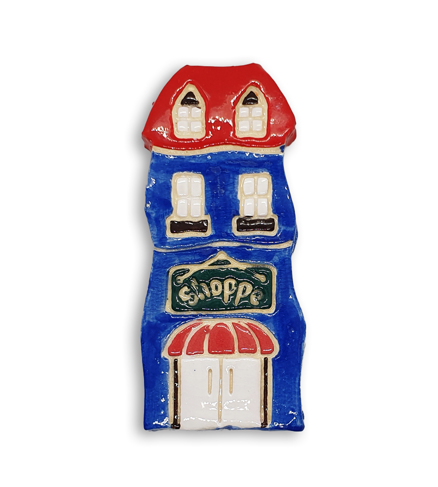 A hand-painted blue house ceramic mosaic insert with a red roof and old fashioned black Shoppe sign.