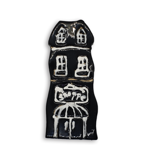 A hand-painted black house ceramic mosaic insert with an old fashioned Shoppe sign.