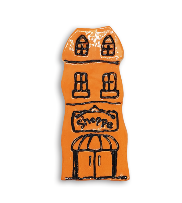 A hand-painted orange house ceramic mosaic insert with an old fashioned Shoppe sign.