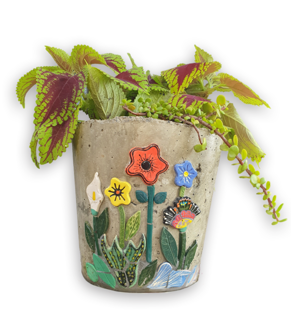 A cement planter pot with colourful flower ceramic inserts.
