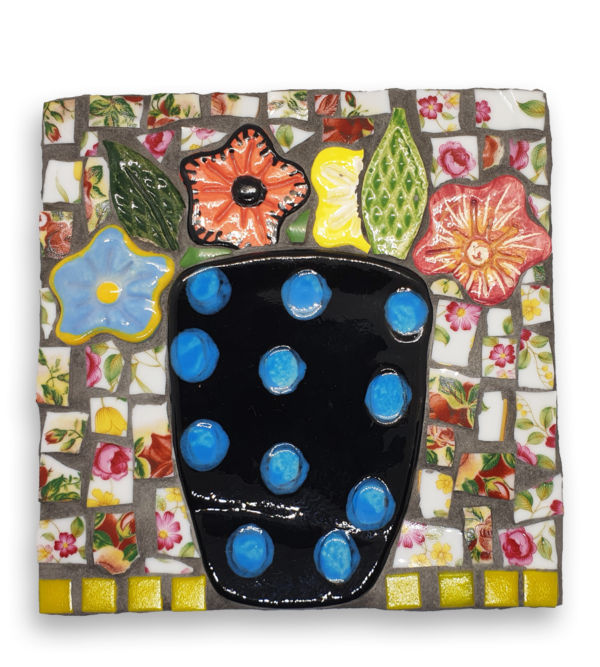 A mosaic depicting a black and blue polka dot vase filled with brightly coloured flower ceramic inserts.