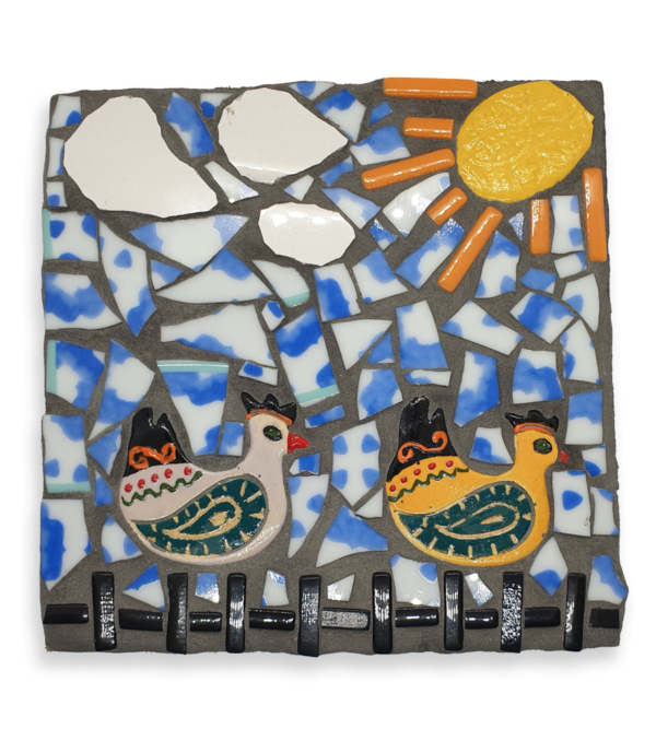 A mosaic depicting two hen ceramic inserts under a sunny sky.