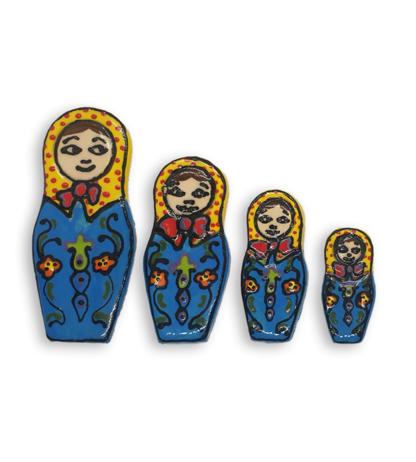 A set of four hand-painted Russian Doll ceramic mosaic inserts with blue dresses, yellow headscarves spotted with red and bright red neck bows.