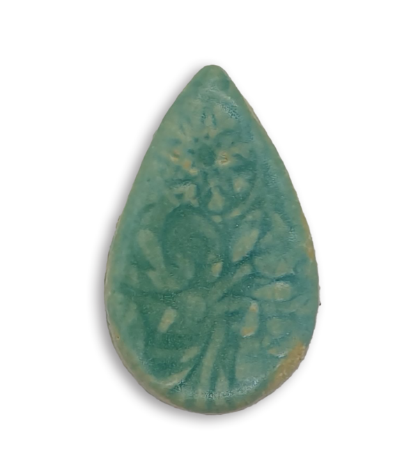 A pale greenish blue teardrop ceramic mosaic insert with a textured design.