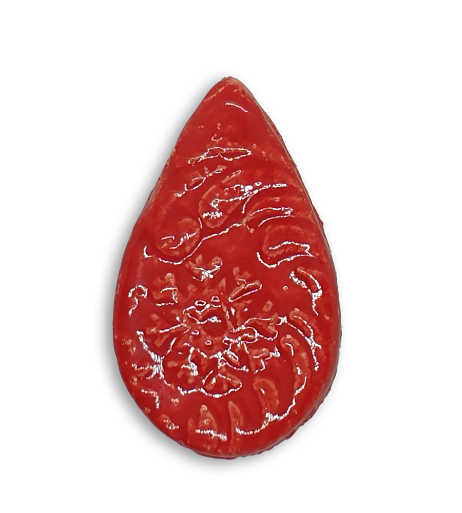 A red teardrop ceramic mosaic insert with a textured design.