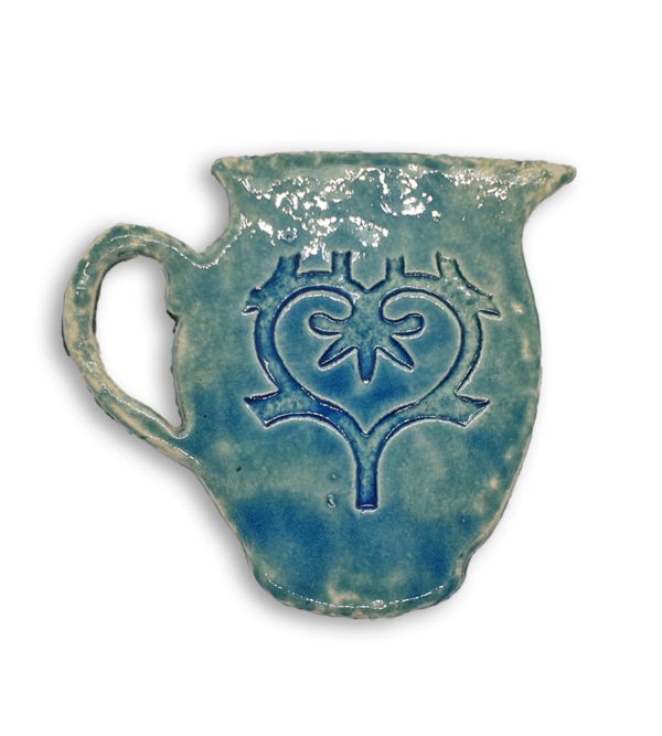 A hand-painted blue jug ceramic mosaic insert with a swirling heart design.