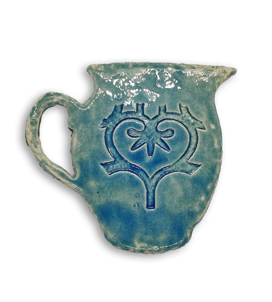A hand-painted blue jug ceramic mosaic insert with a swirling heart design.